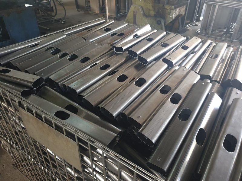 Formed steel desk-frame components stacked after fabrication