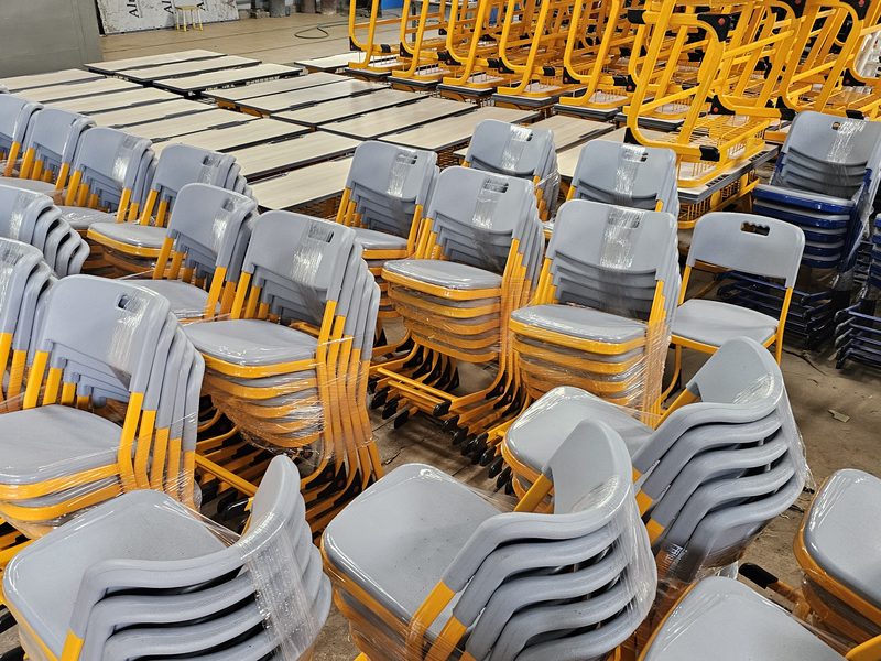 Stacked classroom chairs awaiting despatch