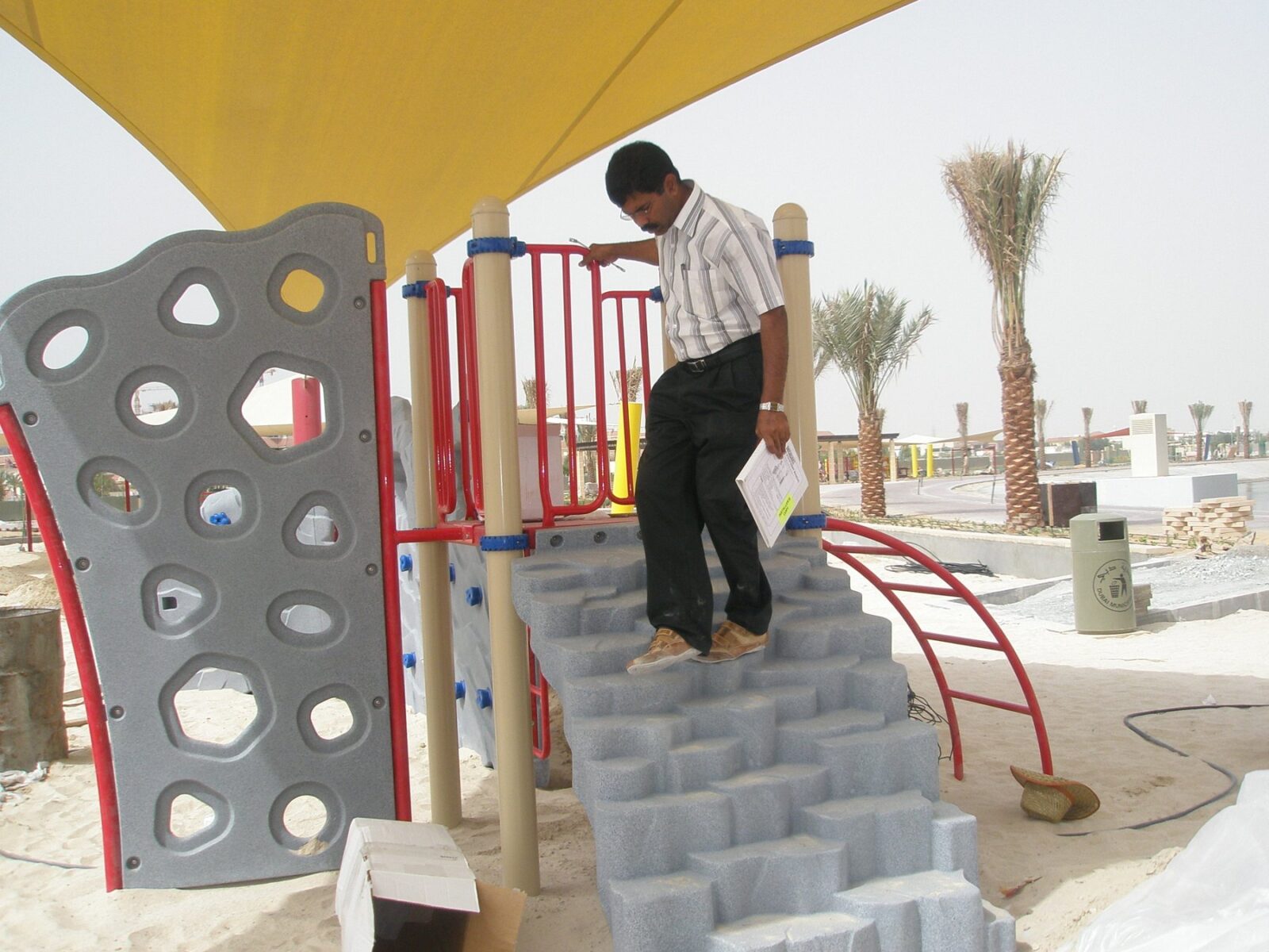 Climbing wall with boulder steps and arch ladder